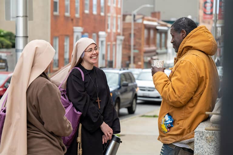 Nuns talking to man